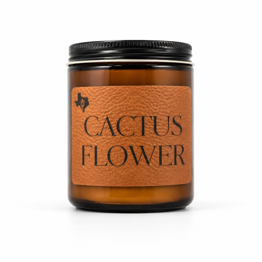 Cactus Flower 8oz soy candle in an amber glass jar with a black lid and a leather label reading 'Cactus Flower', hand-poured by Texas Candles.