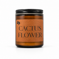 Cactus Flower 8oz soy candle in an amber glass jar with a black lid and a leather label reading 'Cactus Flower', hand-poured by Texas Candles.